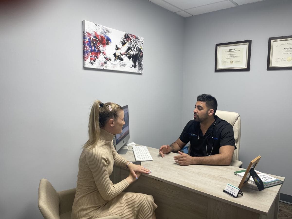Dr. Dhaliwal consulting with a patient